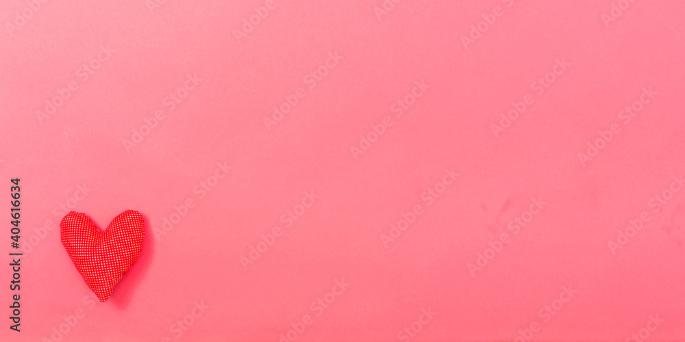 Valentine's day heart shaped pillow on a pink paper background