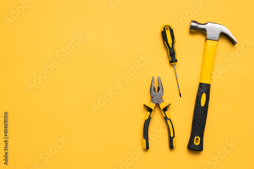 Construction tools on the yellow flat lay background with copy space.