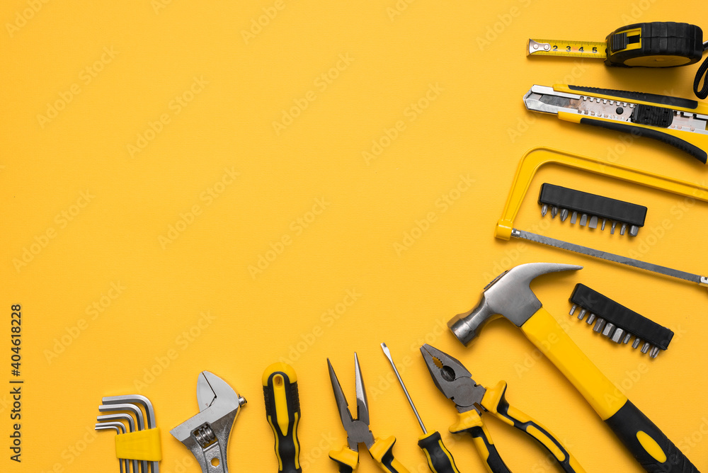 Construction tools on the yellow flat lay background with copy space. - obrazy, fototapety, plakaty 