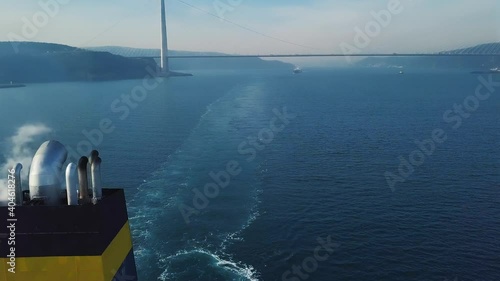 Topmost of a cargo ship underway. VDR capsule, AIS antennas, Radar scanner attached to the radar mast, Sat Tx Rx antennae, communication equipment gear. Funnel, chimney or smokestack on a ship utilize photo