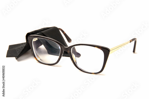 Rectangular plastic oversized eyeglasses frames for women and black microfiber cleaning cloth isolated on a white background