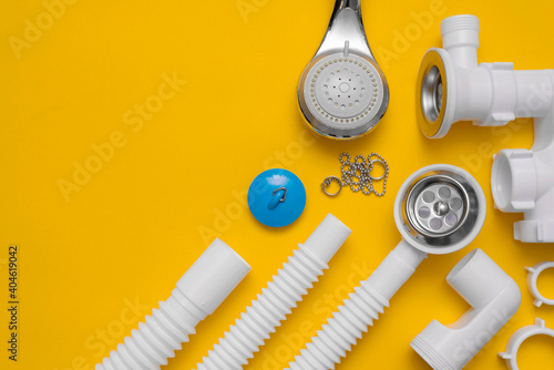 Bild auf Leinwand Shower siphon plastic parts on the yellow background with copy space