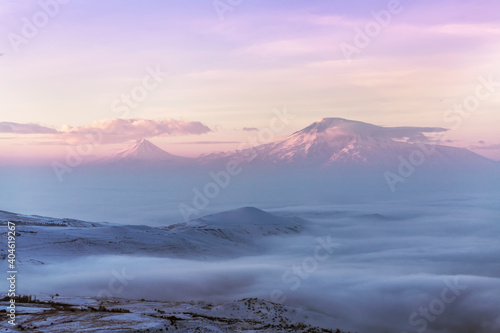 Beautiful sunrise with long exposure clouds. The mountains in a clouds and fog. Ararat mountain. © Inga Av