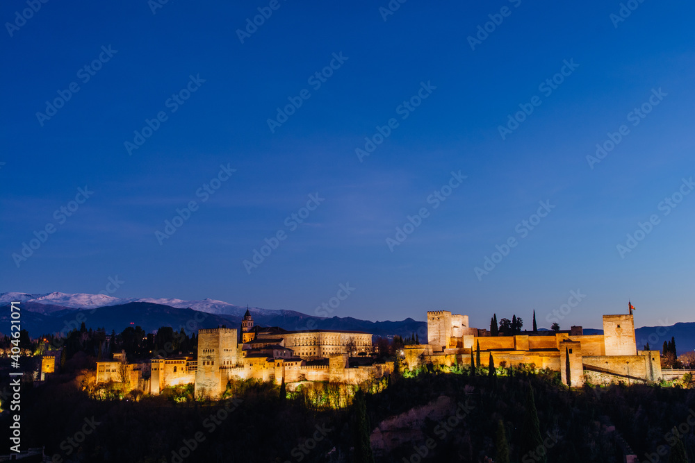 Alhambra palace in Granada at blue hour with blue sky in the top from San Nicolas lookout