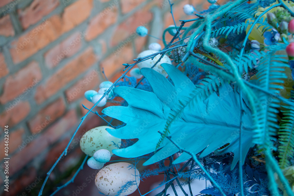 Stylish easter bouquet in blue tones over brick wall background, selective focus, copy space Stylish easter bouquet in blue tones over brick wall background, selective focus, copy space