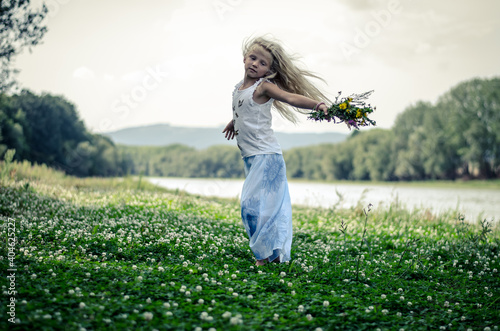 child in the nature having good time dancing wild