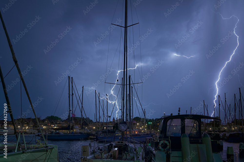 it lightning during the thunderstorm at the port of Urk - obrazy, fototapety, plakaty 