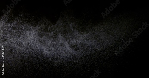 Water Spray against Black Background. Aerosol Sprays Small Drops of Water. Slow Motion in 300 fps. Spray the liquid in the air. Micro drops of water fly in the air.