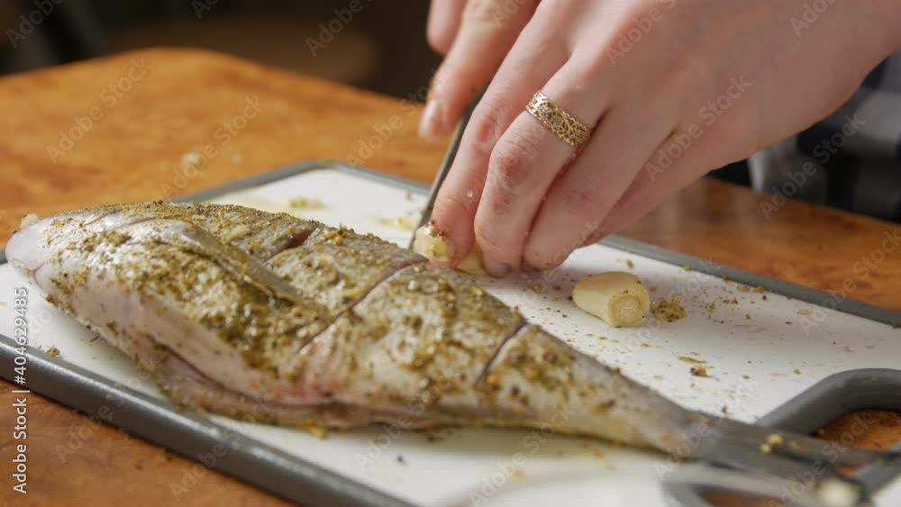 Chopping garlic cooking fish seasoning and foil Chopping garlic cooking fish seasoning and foil