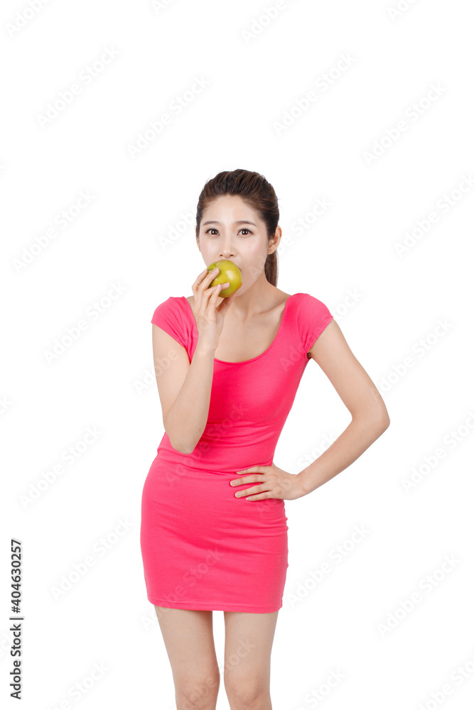 Young woman in pink dress holding apple Young woman in pink dress holding apple