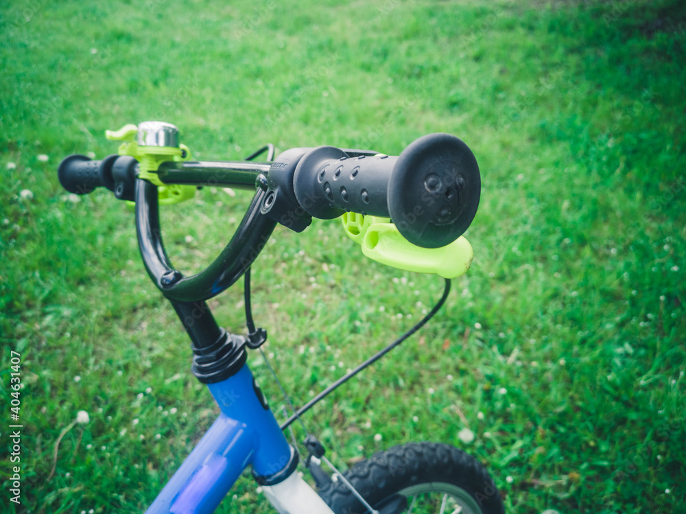bike parts for teen boy standing in the summer park outdoors, wheel closeup bike parts for teen boy standing in the summer park outdoors, wheel closeup