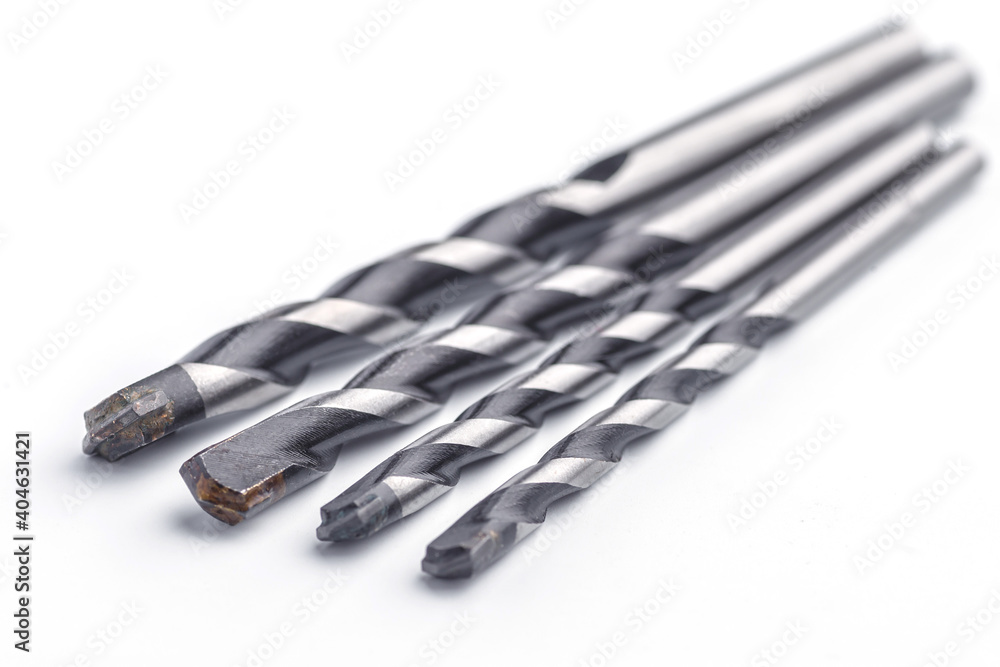 Drill bits made from Titanium isolated over white background. Drill bits of different sizes.set of working tools Drill bits made from Titanium isolated over white background. Drill bits of different sizes.set of working tools