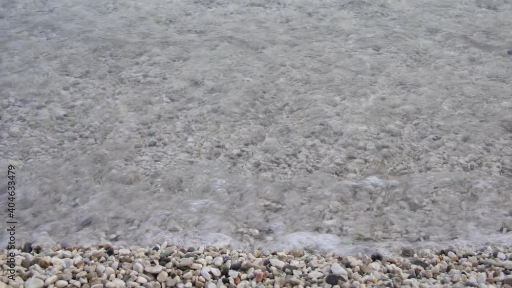 Shingle beach and relaxed waves of sea. Close-up Shingle beach and relaxed waves of sea. Close-up