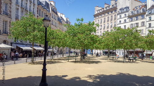 Photography Place Dauphine in Paris with houses, restaurants, cafes