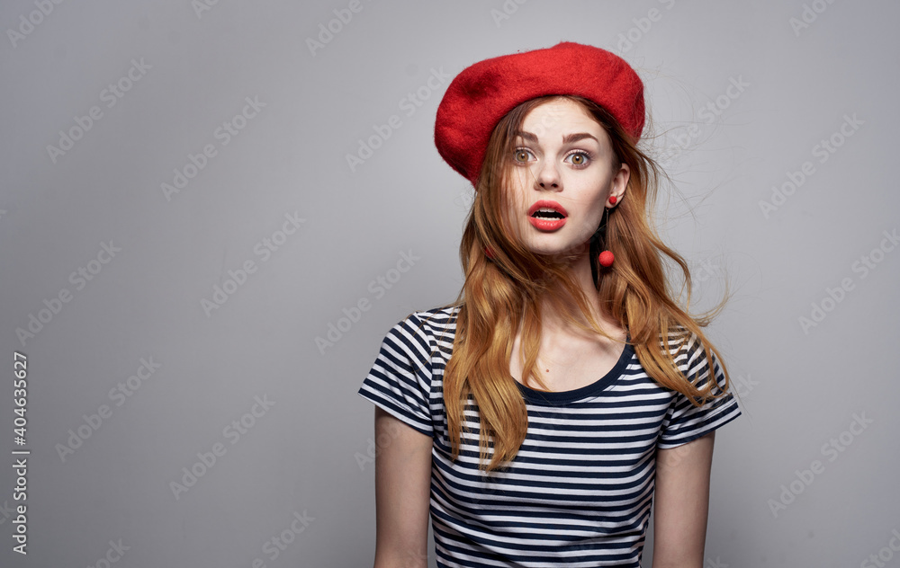 woman in a red beret and a striped t-shirt on a light background cropped view Copy Space woman in a red beret and a striped t-shirt on a light background cropped view Copy Space