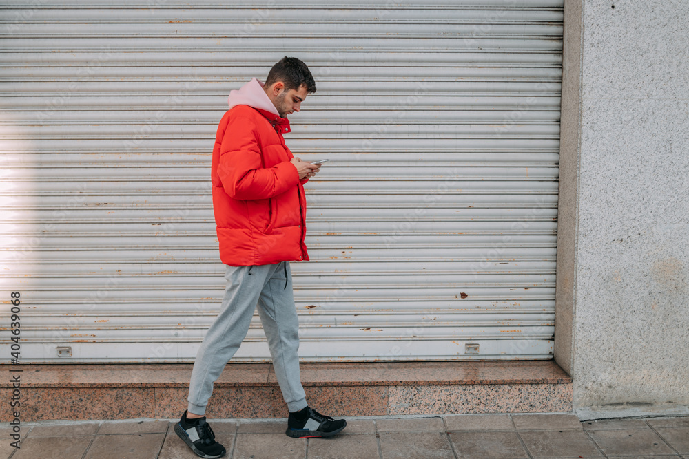 young man talking on mobile phone in the street young man talking on mobile phone in the street