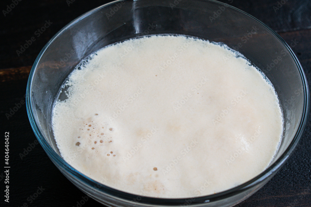 Proofing Active Dry Yeast: Yeast and sugar foaming up in warm water Proofing Active Dry Yeast: Yeast and sugar foaming up in warm water
