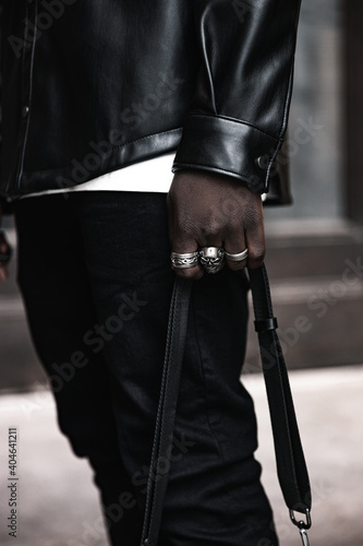 Fashion black man walking on street. Fashionable portrait of african american male model. Street style