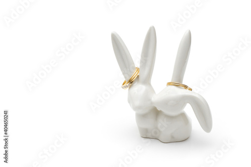 Cute ceramic bunnies ring holder on white with copy space photo