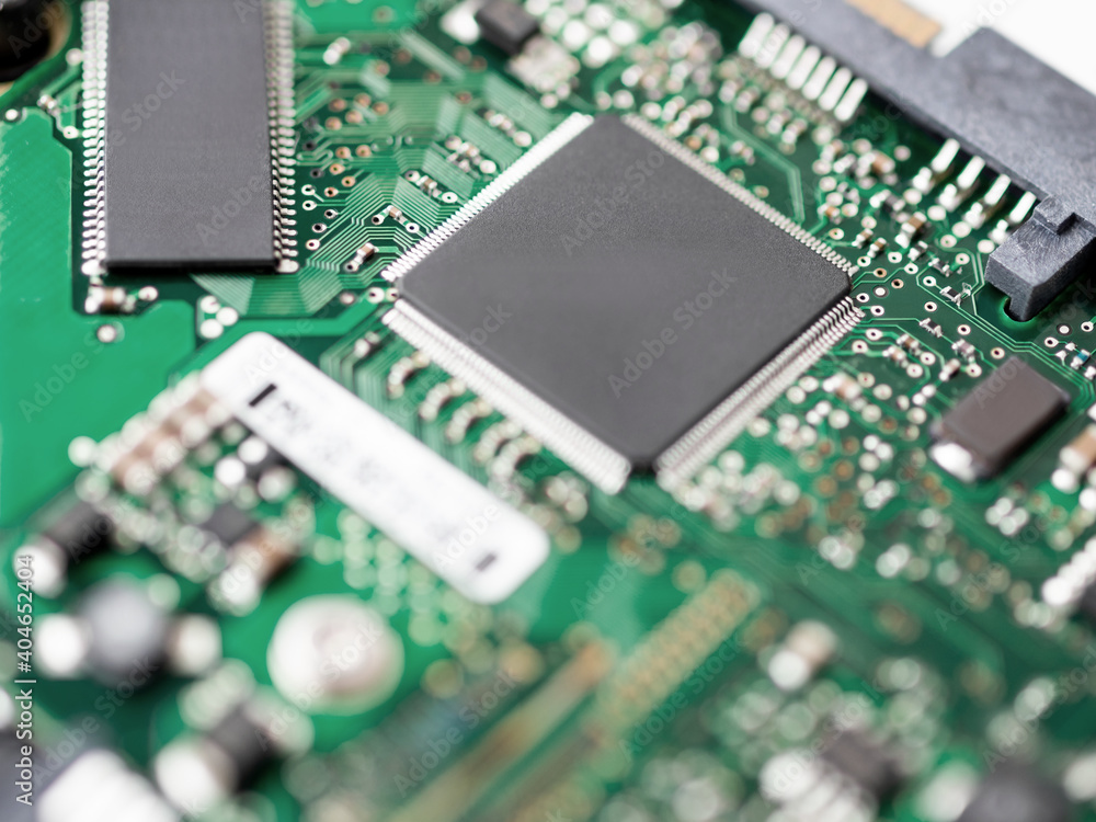 Macro photo of hard disk controller board. IT detail in computer. Technical background. Macro photo of hard disk controller board. IT detail in computer. Technical background.