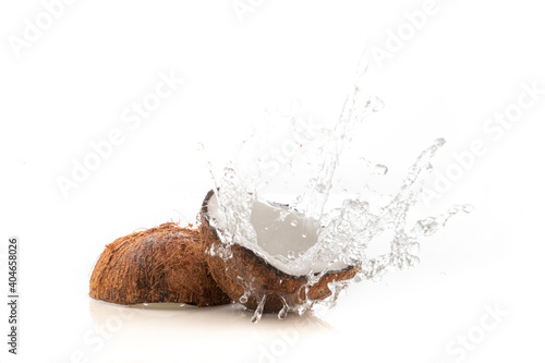 Cracked coconut with water splash on white background © byjeng