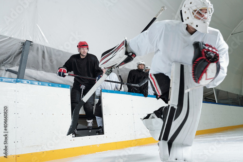 Photography Professional hockey players in uniform and skates going out to ice rink for play