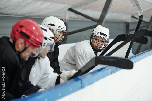 Photography Group of young hockey players in sports uniform and helmets preparing for play