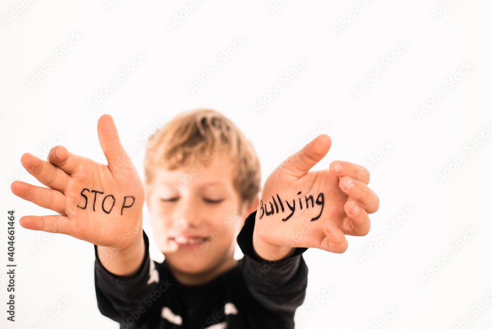 Stop Bullying written on the palms of a child in a black t-shirt ...