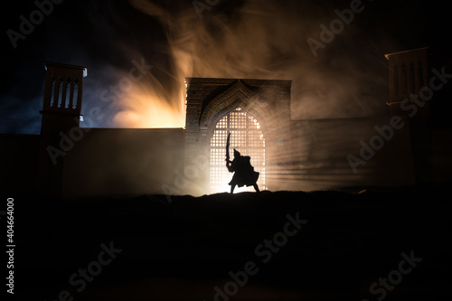 Medieval battle scene with cavalry and infantry. Silhouettes of figures as separate objects, fight between warriors on sunset foggy background. © zef art