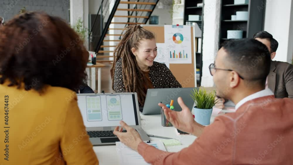 Creative team of designers are discussing smartphone apps then doing high-five working together in office. Teamwork and modern technology concept. Creative team of designers are discussing smartphone apps then doing high-five working together in office. Teamwork and modern technology concept.