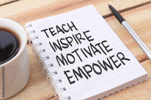 Teach inspire motivate empower, text words typography written on paper against wooden background, life and business motivational inspirational photo