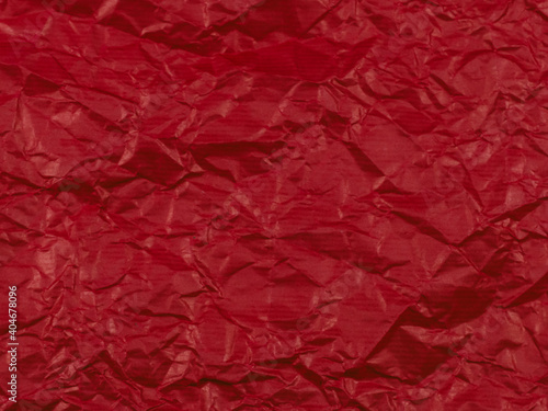  Texture, background of crumpled paper of dark red color, top view close-up.