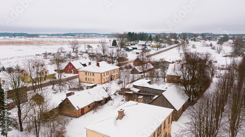 Akniste, Jekabpils, Latvia, Baltics.Beautiful panoramic aerial view photo from flying drone to Akniste city in winter.Beautiful winter view with snowy snow on small town fields and forests. (series) photo