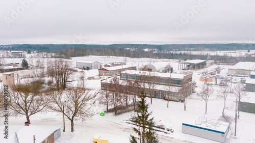 Akniste, Jekabpils, Latvia, Baltics.Beautiful panoramic aerial view photo from flying drone to Akniste city in winter.Beautiful winter view with snowy snow on small town fields and forests. (series) photo