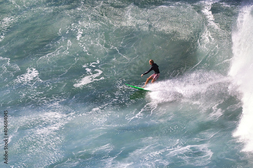 Distant view of a very active surfer seen from above.
