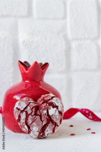 Heart shaped cookies for Valentine's Day and ceramic pomegranatered. photo