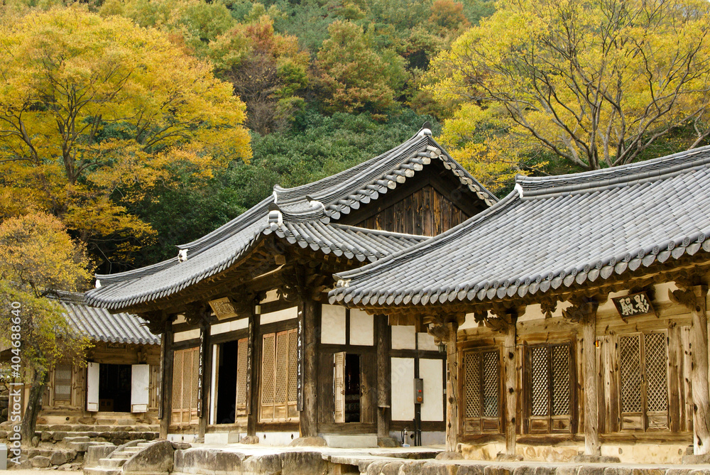 Old wood buildings with tile roofs comprise Hwaeomsa (Hwaeom-sa) Buddhist temple which is photographed here during autumn in Jirisan National Park, South Korea.