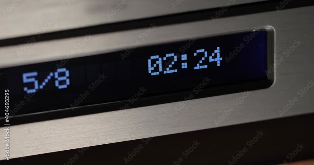 Hi-fi CD player in use, track time display in dim evening light, tranquil listening session Hi-fi CD player in use, track time display in dim evening light, tranquil listening session