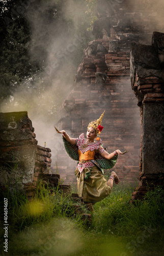 Beautiful woman in traditional Thai dress costume, Asian woman, is dancing, Traditional thai style. © Siriporn