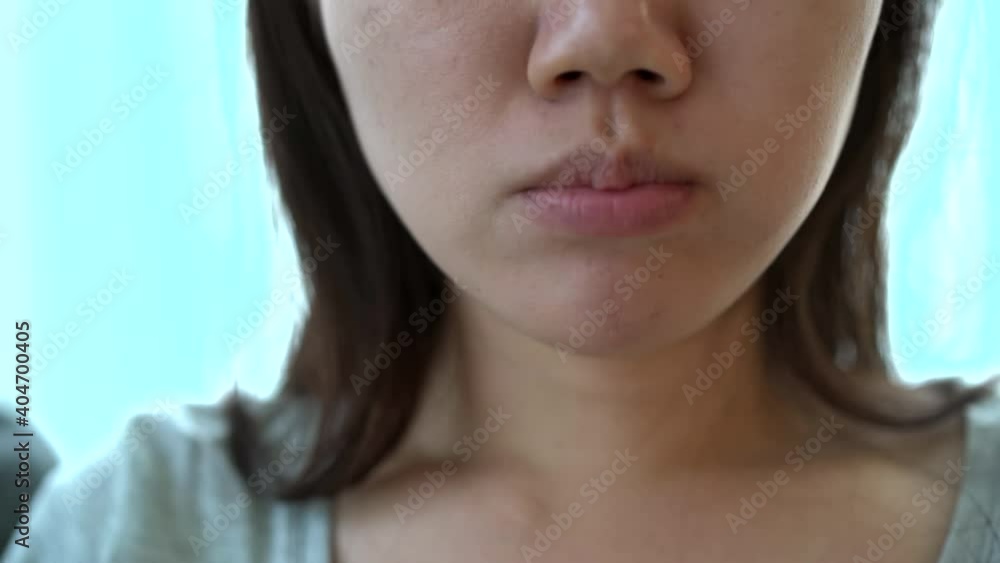 happy asian young woman relaxing in living room on sofa and eating a piece of pizza while watching a tv. happy asian young woman relaxing in living room on sofa and eating a piece of pizza while watching a tv.