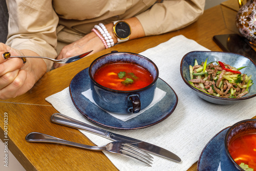 A fragment of the table setting in a restaurant or cafe. Salad, first and second course. The concept of the business lunch.