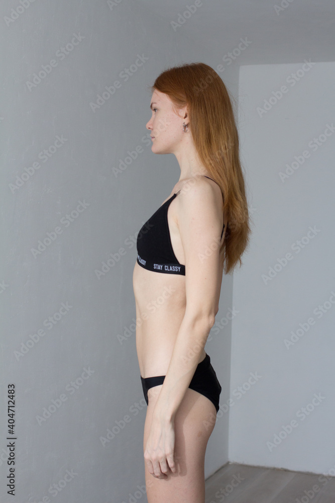 snap shot of pretty model in black lingerie on white background with red hair snap shot of pretty model in black lingerie on white background with red hair