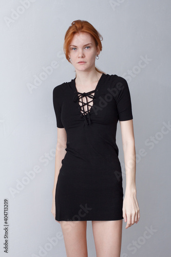 portrait of a red hair woman in short black dress