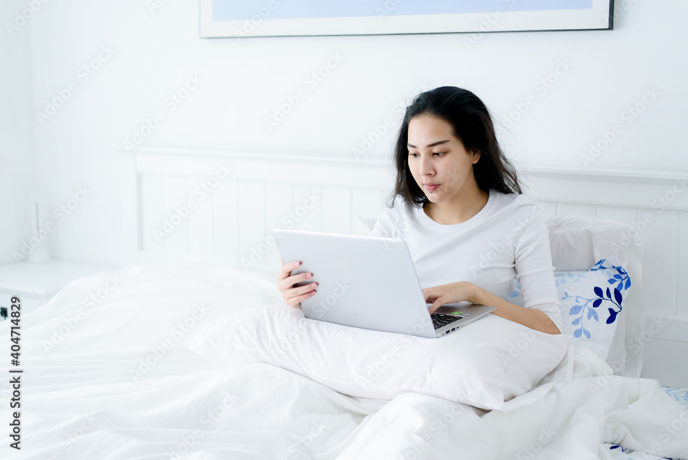 Young woman working from home in bedroom Young woman working from home in bedroom