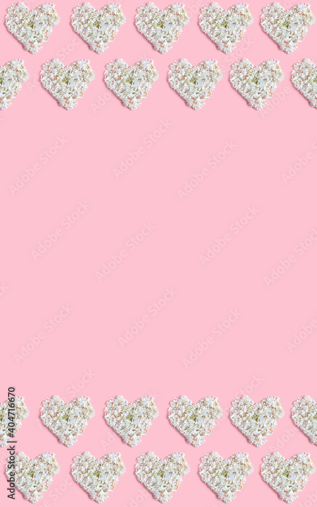 Valentine's day floral concept. a beautiful frame of white hearts on a pink background. copy space, flat lay, vertical frame