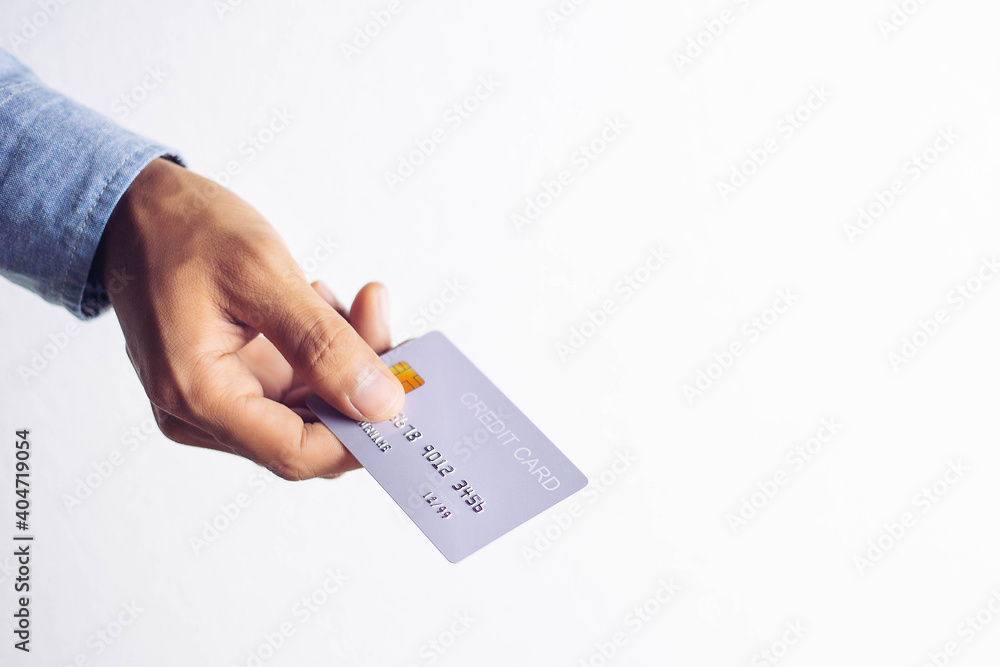 Close-up of man hand holding plastic credit cardOnline shopping concept. Close-up of man hand holding plastic credit cardOnline shopping concept.