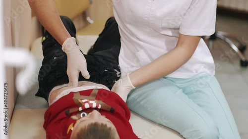 Pediatrician doing checkup on young boy.