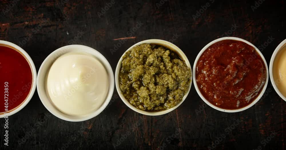 On the table are different sauces in bowls. On the table are different sauces in bowls.