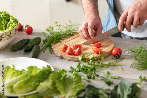 Man preparing delicious and healthy lunch at home kitchen