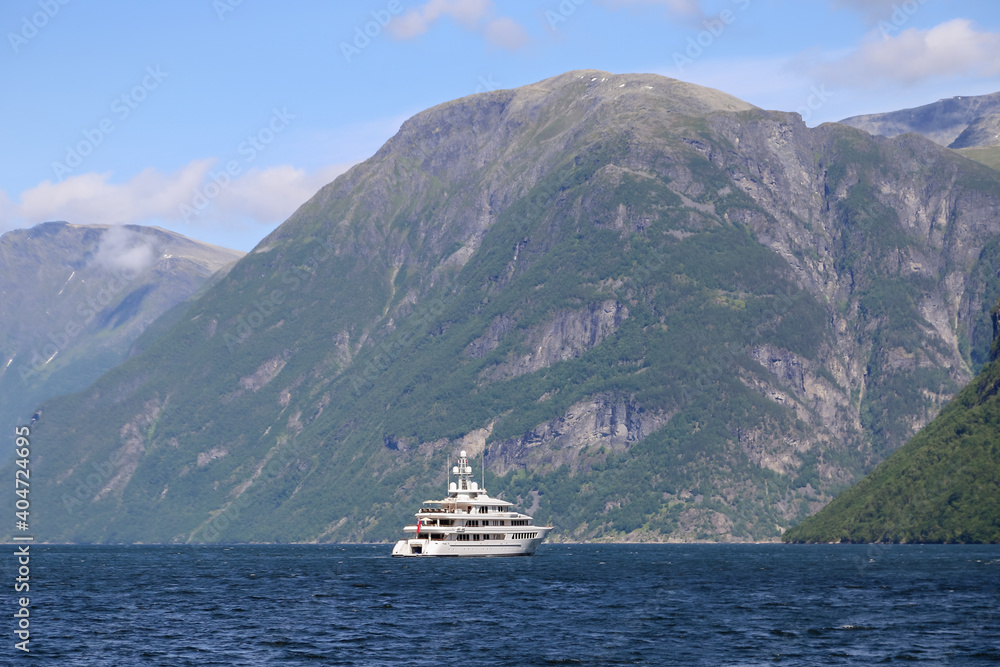A mega yacht anchored in the fjords of Norway